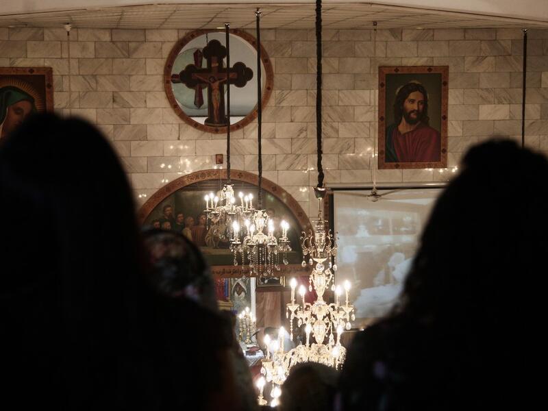 Sudanese Copts attend Christmas midnight mass at the capital Khartoum's Martyrs Church late on January 6, 2021, as the Orthodox Christian faith uses the old Julian calendar in which Christmas falls 13 days after the date in the more widespread Gregorian calendar.  Ebrahim HAMID / AFP