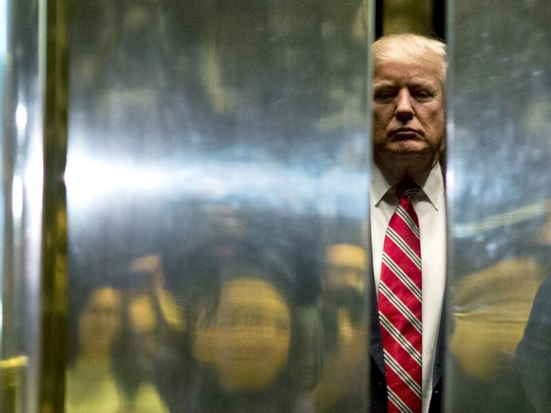 AFP presents a retrospective photo package of 60 pictures marking the 4-year presidency of President Trump. US President-elect Donald Trump boards the elevator after escorting Martin Luther King III to the lobby after meetings at Trump Tower in New York City on January 16, 2017. DOMINICK REUTER / AFP