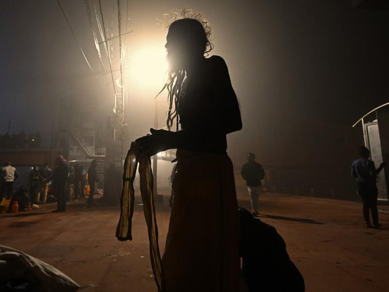 A Hindu devotee prepares to take a holy dip in the waters of river Ganges during Makar Sankranti, a day considered to be of great religious significance in Hindu mythology, on the first day of the religious Kumbh Mela festival in Haridwar on January 14, 2021. Money SHARMA / AFP