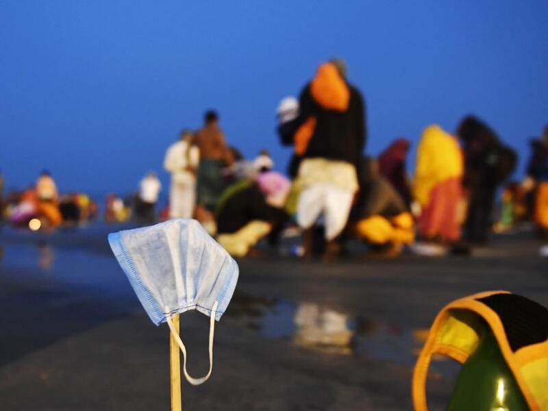 Facemasks of Hindu pilgrims kept for drying are pictured at the confluence of Ganges and the Bay of Bengal during the Gangasagar Mela on the occasion of Makar Sankranti, a day considered to be of great religious significance in Hindu mythology, at Sagar Island, around 150 kms south of Kolkata on January 14, 2021. Dibyangshu SARKAR / AFP
