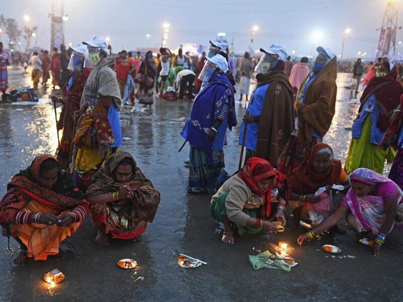 Members of local village panchayat wearing face shields and masks inspect the sanitization on the beach as a preventive measure against the Covid-19 coronavirus as Hindu pilgrims perform rituals at the confluence of Ganges and the Bay of Bengal during the Gangasagar Mela on the occasion of Makar Sankranti, a day considered to be of great religious significance in Hindu mythology, at Sagar Island, around 150 kms south of Kolkata on January 14, 2021. Dibyangshu SARKAR / AFP