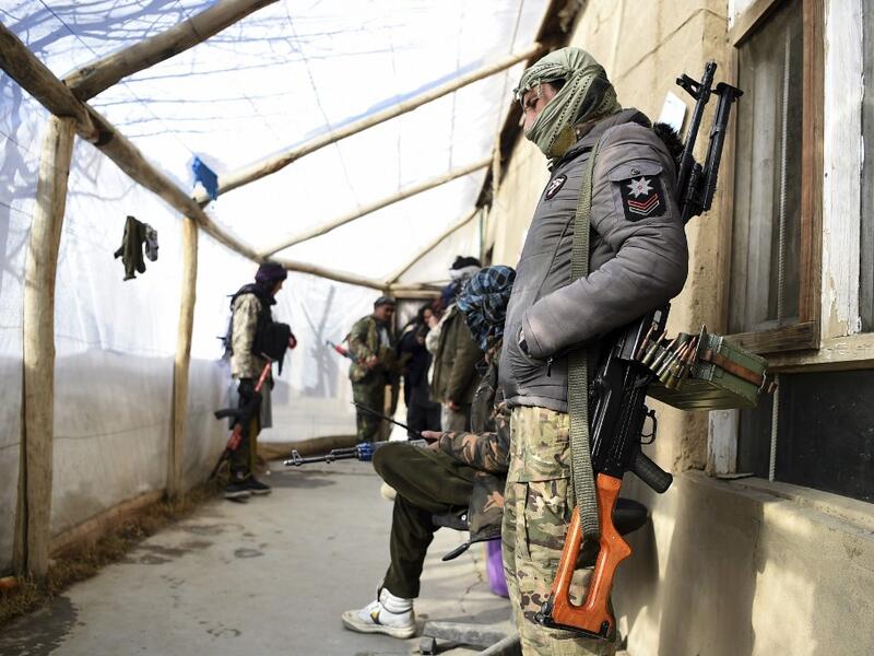 In this photo taken on January 9, 2021, Hazara armed militia for the Resistance for Justice Movement, stand inside their base ahead of a patrol against Taliban insurgents at Hisa-e-Awali Behsud district of Maidan Wardak Province. Comprising roughly 10 to 20 percent of Afghanistan's 38-million population, Hazaras have long been persecuted for their largely Shiite faith by Sunni hardliners in a country wracked by deep ethnic divisions. WAKIL KOHSAR / AFP