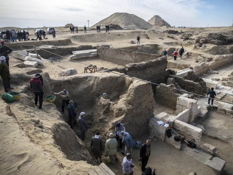 Workers excavate a site during the official announcement of the discovery by an Egyptian archaeological mission of a new trove of treasures at Egypt's Saqqara necropolis south of Cairo, on January 17, 2021. The discovery at the necropolis which lies 30kms south of the Egyptian capital, includes the funerary temple of Queen Naert, wife of King Teti, as well as burial shafts, coffins, and mummies dating back to nearly 3000 years ago during the New Kingdom. Khaled DESOUKI / AFP