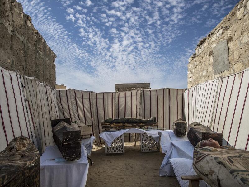 Unearthed adorned wooden sarcophagi are displayed during the official announcement of the discovery by an Egyptian archaeological mission of a new trove of treasures at Egypt's Saqqara necropolis south of Cairo, on January 17, 2021. The discovery at the necropolis which lies 30kms south of the Egyptian capital, includes the funerary temple of Queen Naert, wife of King Teti, as well as burial shafts, coffins, and mummies dating back to nearly 3000 years ago during the New Kingdom. Khaled DESOUKI / AFP