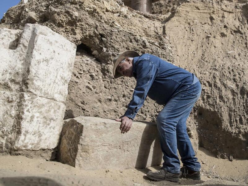 Egyptologist Zahi Hawass examines inscriptions on an unearthed structure during the official announcement of the discovery by an archaeological mission he leads of a new trove of treasures at Egypt's Saqqara necropolis south of Cairo, on January 17, 2021. The discovery at the necropolis which lies 30kms south of the Egyptian capital, includes the funerary temple of Queen Naert, wife of King Teti, as well as burial shafts, coffins, and mummies dating back to nearly 3000 years ago during the New Kingdom. Khal