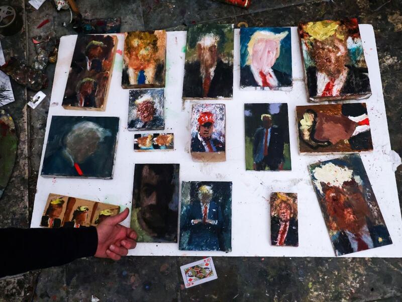 Israeli painter Iddo Markus displays some of his paintings of former US president Donald Trump, at his studio in the northern port city of Haifa, on January 22, 2021. Markus became fascinated by the "tragic figure" of Donald Trump, and the walls and floor of his studio are packed with some 120 portraits of the former US president. Emmanuel DUNAND / AFP