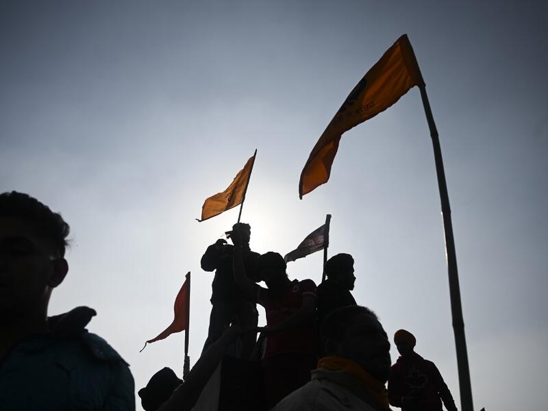 Protesters shout slogans in front of the Red Fort as farmers continue to protest against the central government's recent agricultural reforms in New Delhi on January 26, 2021. Sajjad HUSSAIN / AFP