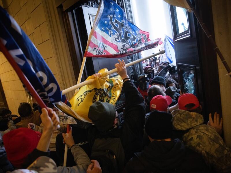 A pro-Trump mob breaks into the U.S. Capitol on January 06, 2021 in Washington, DC. Congress held a joint session today to ratify President-elect Joe Biden's 306-232 Electoral College win over President Donald Trump. A group of Republican senators said they would reject the Electoral College votes of several states unless Congress appointed a commission to audit the election results. Win McNamee/Getty Images/AFP