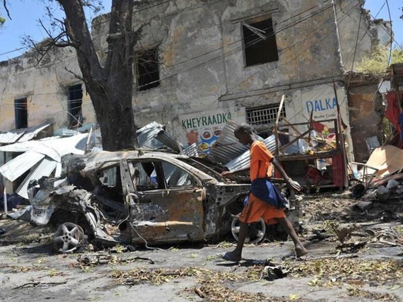 A boy walks past the site of a car bomb attack near a security checkpoint in the Somali capital, not far from the presidential palace in Mogadishu. (File/AFP)