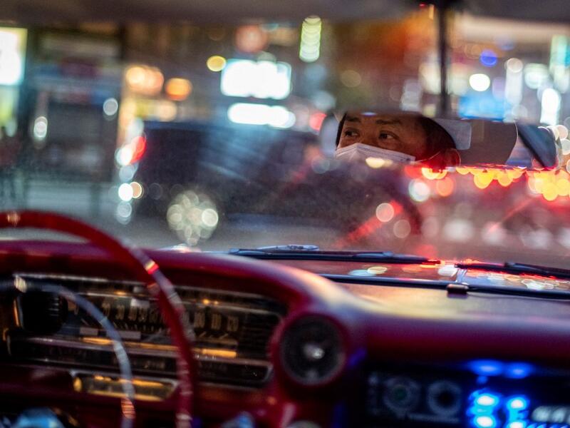 This picture taken on January 16, 2021 shows Hiroyuki Wada, who runs a vintage car service company, driving a 1959 Cadillac Coupe DeVille in Tokyo. A loose club of fans rolls up most weekends in central Tokyo to show off their Cadillacs, Chevrolets and other modern classic vehicles from the mid to late 20th century. Philip FONG / AFP