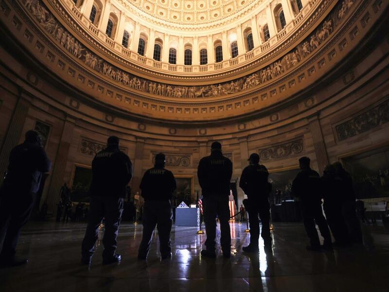 Capitol Police Officers pay their respects to late US Capitol Police officer Brian Sicknick as he lies in honor in the US Capitol Rotunda in Washington, February 2, 2021. US President Joe Biden paid his respects Tuesday at a solemn memorial to the policeman killed last month during an attack on the Capitol by Donald Trump's supporters.  LEAH MILLIS / POOL / AFP