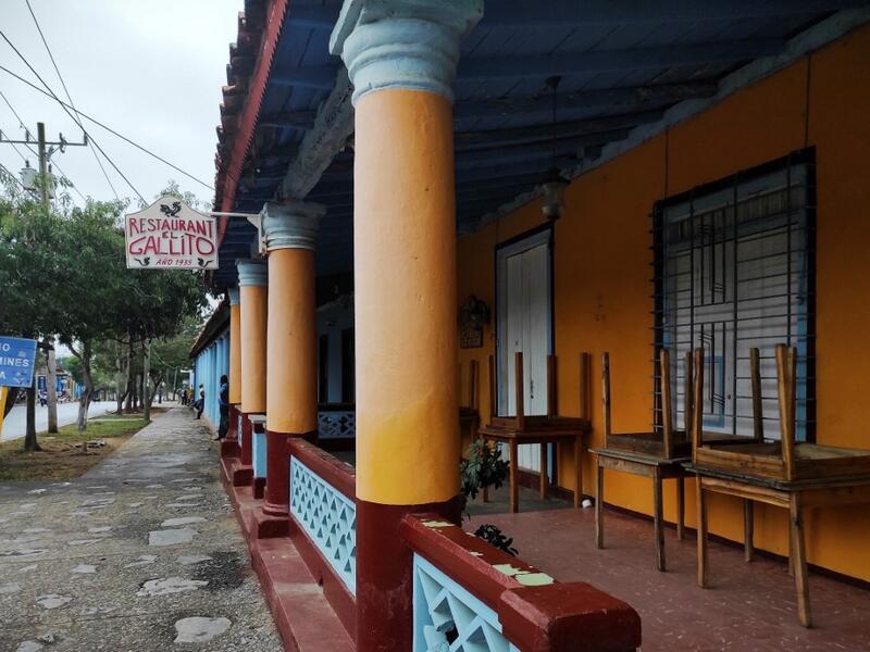 A man walks by a closed private restaurant in Vinales, Cuba, on January 28, 2021. At the foot of the majestic rock formations of Vinales, the terraces of the restaurants look empty and the lodgings have closed. With the arrival of COVID-19, the incipient prosperity of this Cuban town came to a halt and people abandoned tourism jobs to return to work the land. YAMIL LAGE / AFP
