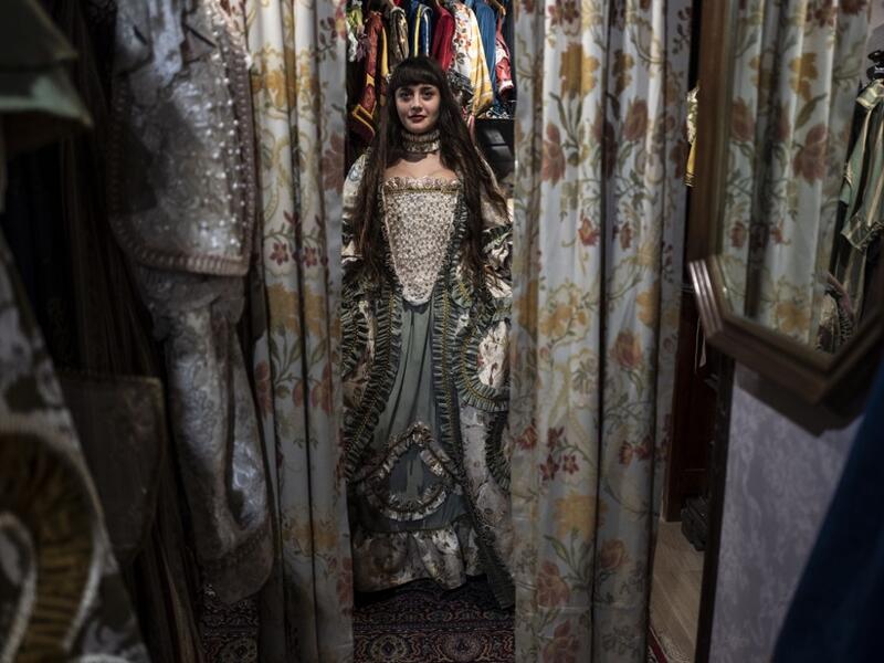 A reveller poses with a traditional carnival costume in 'La Bauta' shop in Venice on February 6, 2021, as the traditional Venice carnival is being cancelled due to the Covid-19 pandemic. Marco Bertorello / AFP