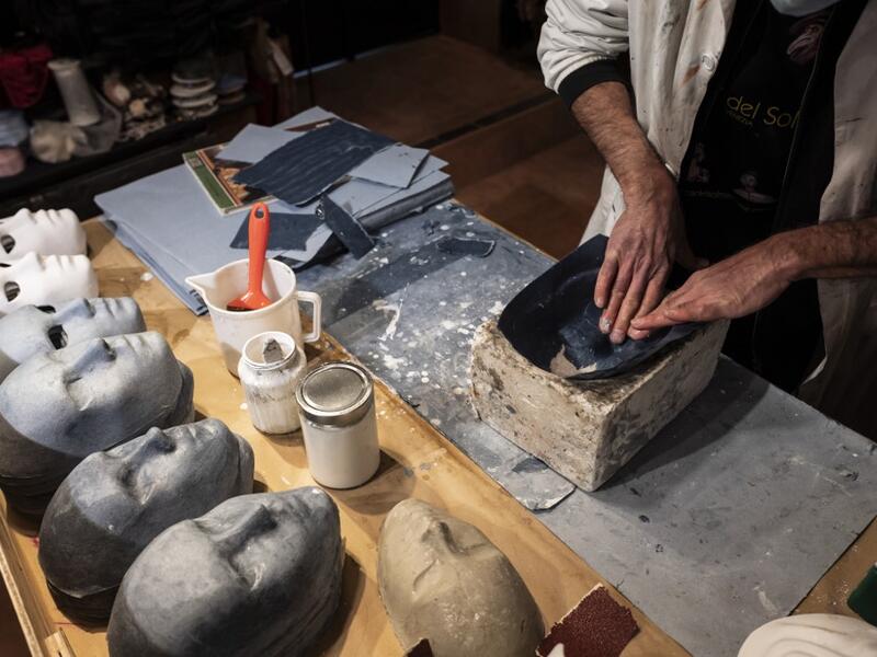 Mask artisan Hamid Seddighi works on a mask in his laboratory 'Ca del Sol' in Venice on February 6, 2021, as the traditional Venice carnival is being cancelled due to the Covid-19 pandemic. Marco Bertorello / AFP