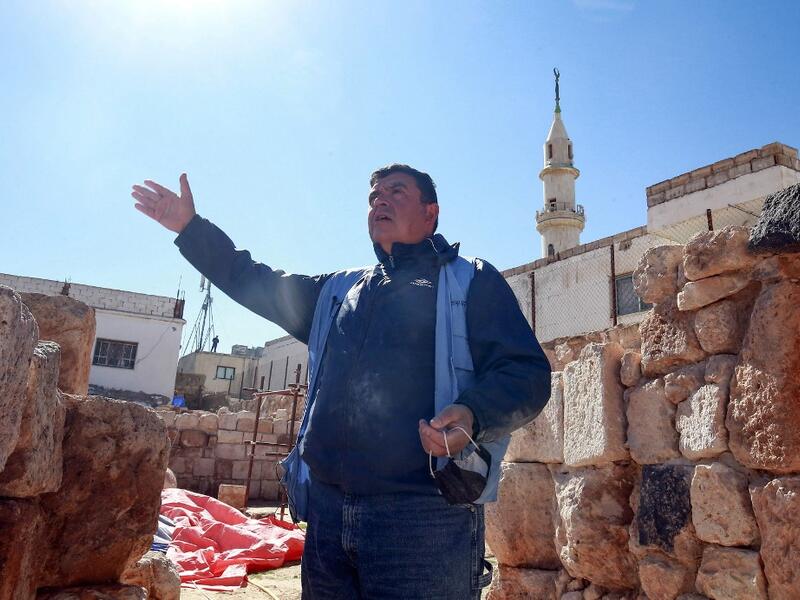 Franco Sciorilli, an Italian expert, speaks to AFP as he supervises workers employed by a pilot project run by the UN cultural agency UNESCO, to restore an ancient church complex, in the small town of Rihab, some 70 kilometres north of the Jordanian capital Amman, on February 9, 2021. In the ruins of the ancient Byzantine church in Jordan, local townspeople and Syrian refugees work side by side on a project that unites preserving cultural heritage and fighting poverty.  Khalil MAZRAAWI / afp