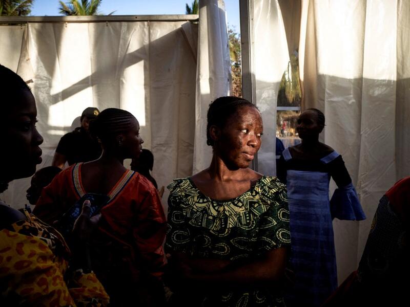 A former gold miner looks on during the first edition of the International Gold Fair Afrik'Or, in Bamako, on February 12, 2021. The Princess of Burundi, selected 34 women among gold mines workers in southern Mali, to walk down the catwalk for a fashion show organised during the International Gold Fair. Gold represents 15% of Mali's exports and more than 20% of its GDP estimated at nearly US$20 billion by the end of 2019. MICHELE CATTANI / AFP