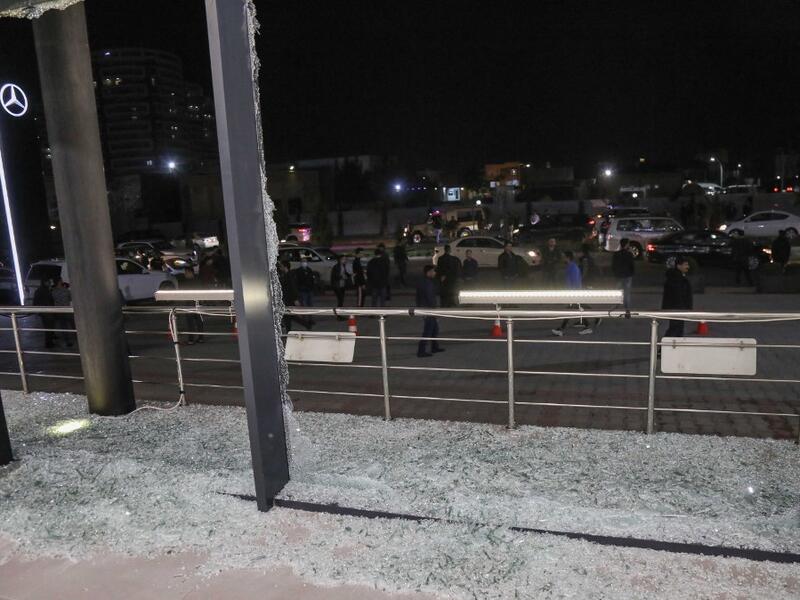 Shattered glass is pictured on the floor of a shop following a rocket attack in Arbil, the capital of the northern Iraqi Kurdish autonomous region, on February 15, 2021. A volley of rockets targeted the Kurdish regional capital in northern Iraq late today, authorities said, as security sources confirmed that at least one hit a military complex hosting US-led coalition troops. SAFIN HAMED / AFP