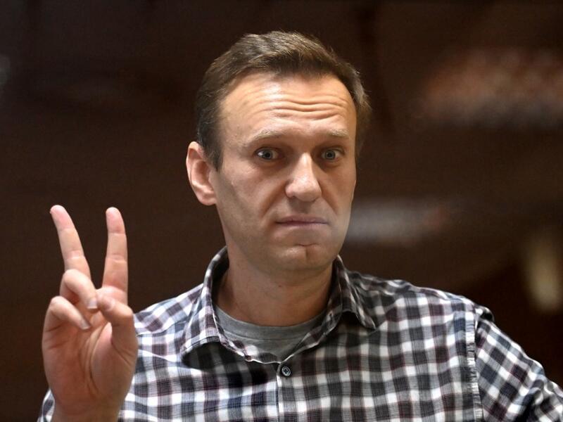 Russian opposition leader Alexei Navalny stands inside a glass cell during a court hearing at the Babushkinsky district court in Moscow on February 20, 2021. The Kremlin's most prominent opponent Alexei Navalny faces two court decisions on Saturday that could seal a judge's ruling to jail him for several years, after he returned to Russia following a poisoning attack. Kirill KUDRYAVTSEV / AFP