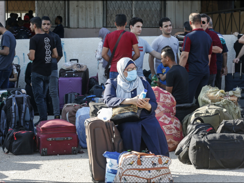 Hundreds of Gazans assembled before dawn in the waiting area. [Said Khatib/AFP]