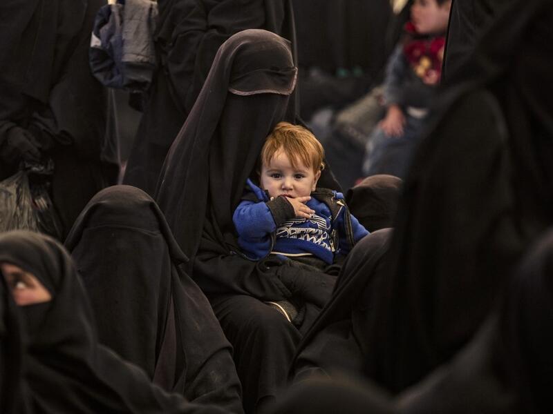 Syrians wait to leave the Kurdish-run al-Hol camp, which holds relatives of alleged Islamic State (IS) group fighters, in the Syrian northeastern al-Hasakeh governorate.