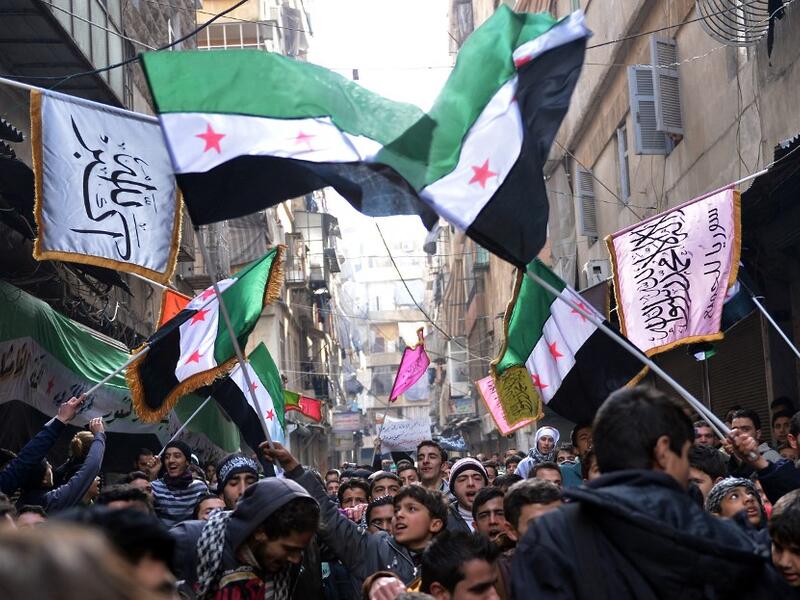 Syrian anti-regime protesters wave pre-Baath Syrian flags
