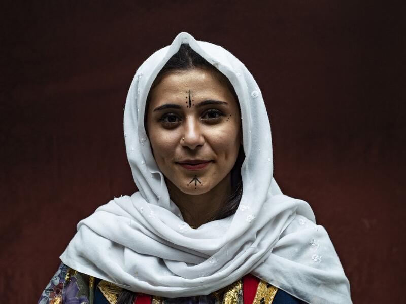 A Syrian Kurdish woman in traditional attire 