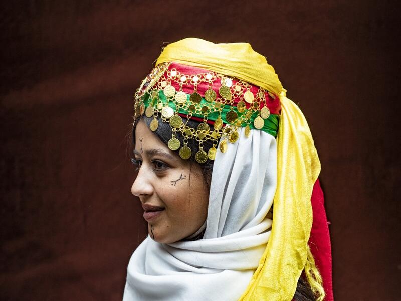 A Syrian Kurdish woman in traditional attire 