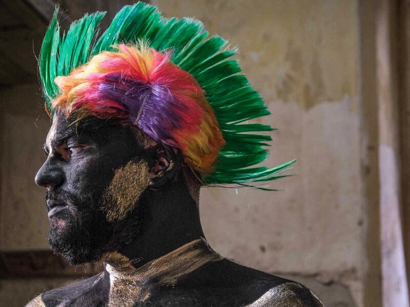 A carnival participant dressed in costume and wearing body paint