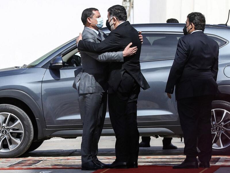 Mohamed al-Manfi (R), head of Libya's presidency council looks on as new interim Prime Minister Abdul Hamid Dbeibah (L) 