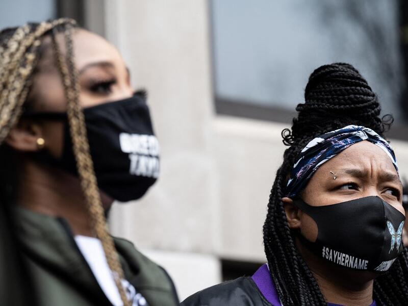 Tamika Mallory (L) speaks as Tamika Palmer listens