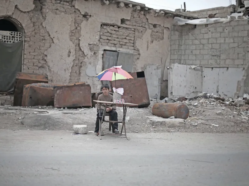 On 29 October 2015 in East Ghouta, rural Damascus, an internally displaced boy sits with items he will sell.