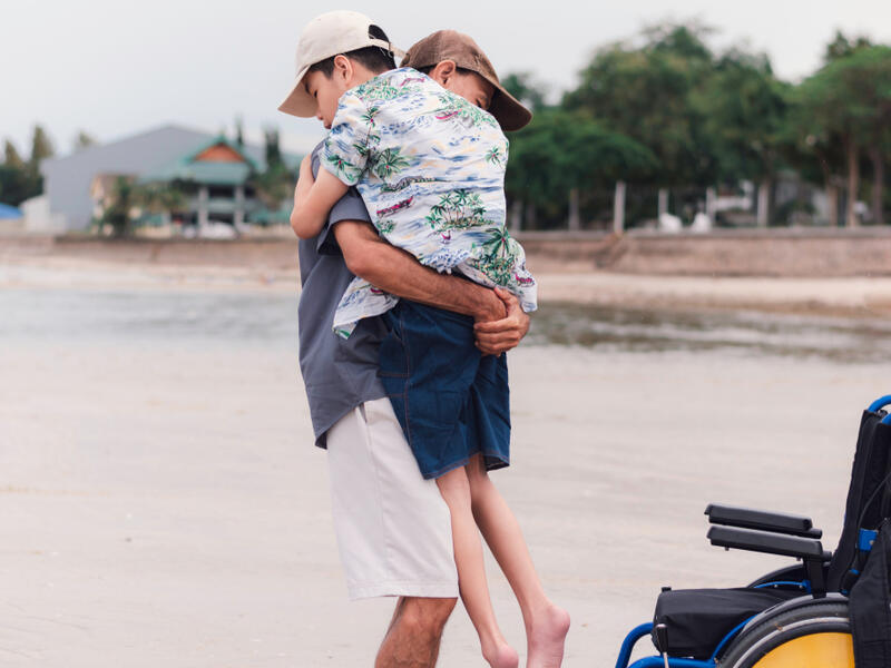 Halil Sahin carries 10-year-old disabled son to school on his back