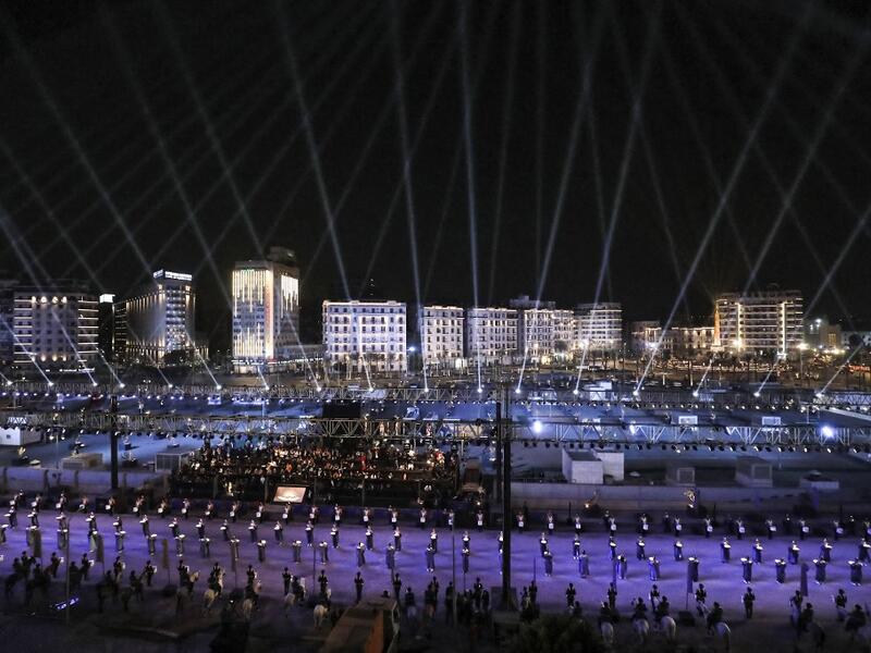 Performers dressed in ancient Egyptian costume wait at the start of the parade of 22 ancient Egyptian royal mummies 