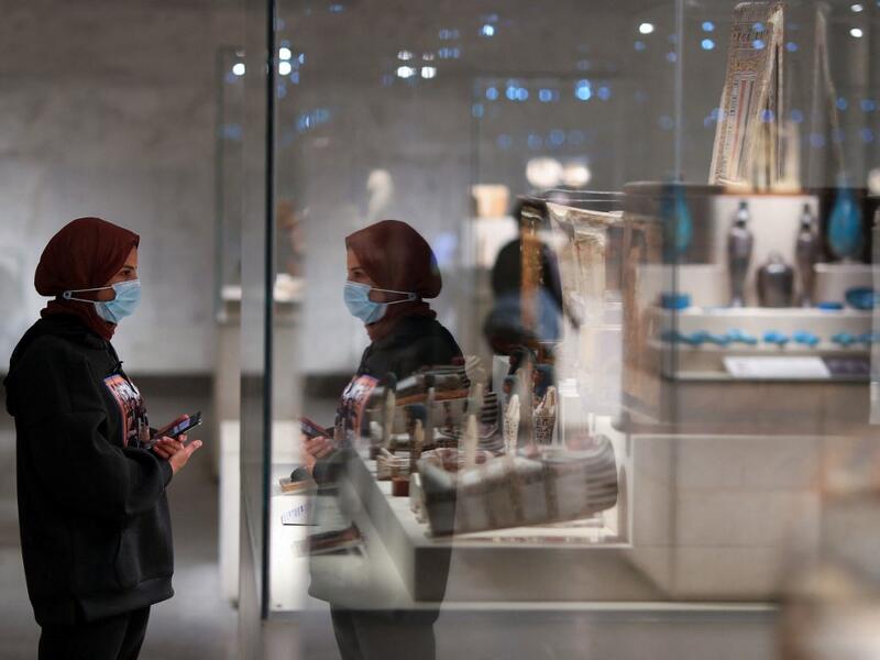 A visitor looks at displayed artifacts at Egypt's new National Museum of Egyptian Civilisation (NMEC) 