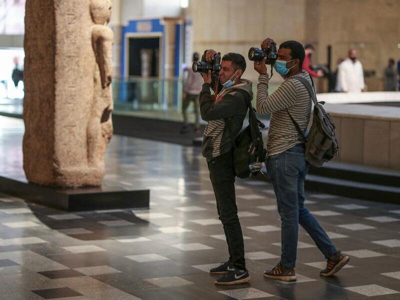 Photojournalists take pictures at Egypt's new National Museum of Egyptian Civilisation 