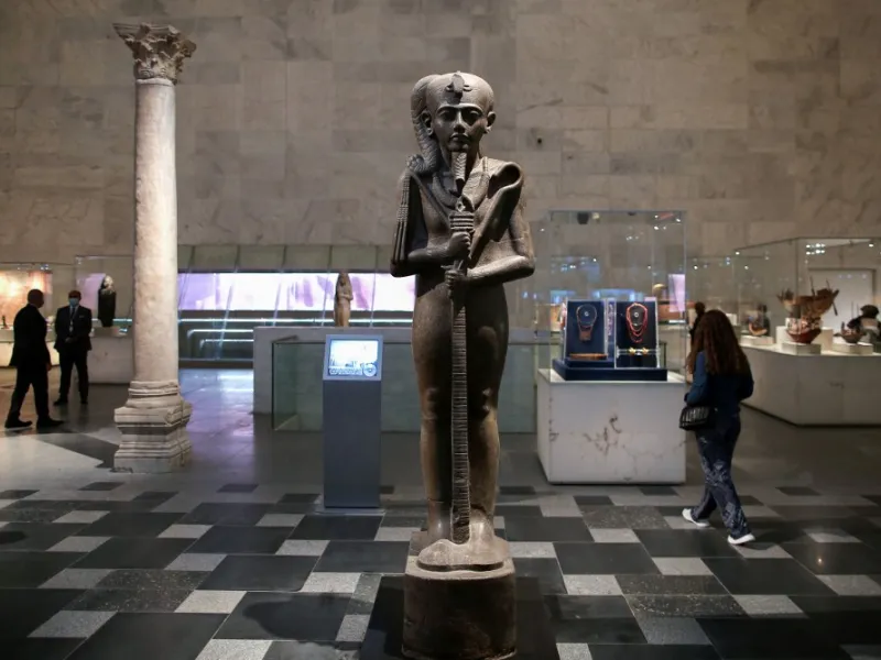 People visit an archaeological exhibit at Egypt's new National Museum of Egyptian Civilisation (NMEC)