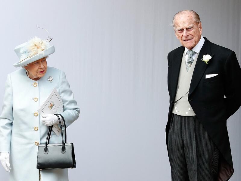 October 12, 2018 Britain's Queen Elizabeth II (L) and Britain's Prince Philip, Duke of Edinburgh (R) wait for the carriage carrying Princess Eugenie of York and her husband Jack Brooksbank 