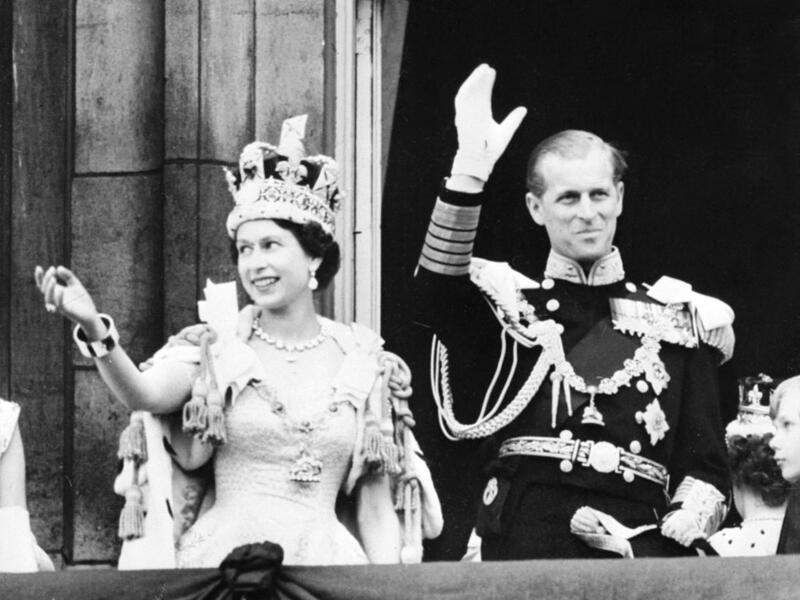  June 2, 1953 Britain's Queen Elizabeth II (L) accompanied by Britain's Prince Philip, Duke of Edinburgh (R) waves to the crowd, June 2, 1953 