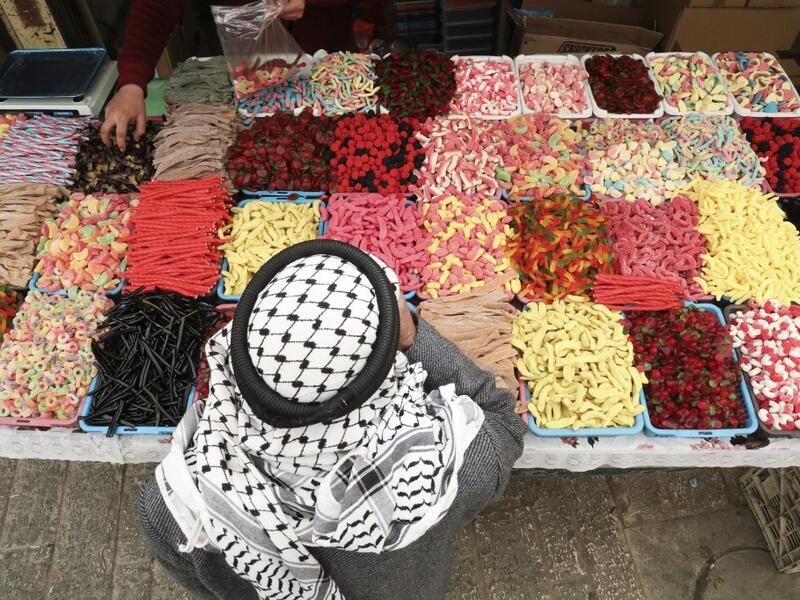 A Palestinian street vendor sells candy and sweets in Hebron's Old City in the Israeli-occupied West Bank 