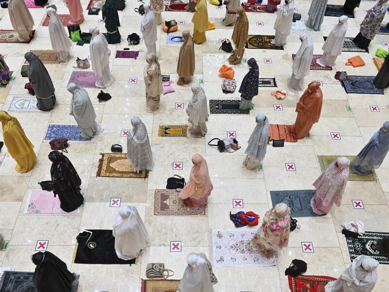 Muslim women offer prayers on the first night of Ramadan 