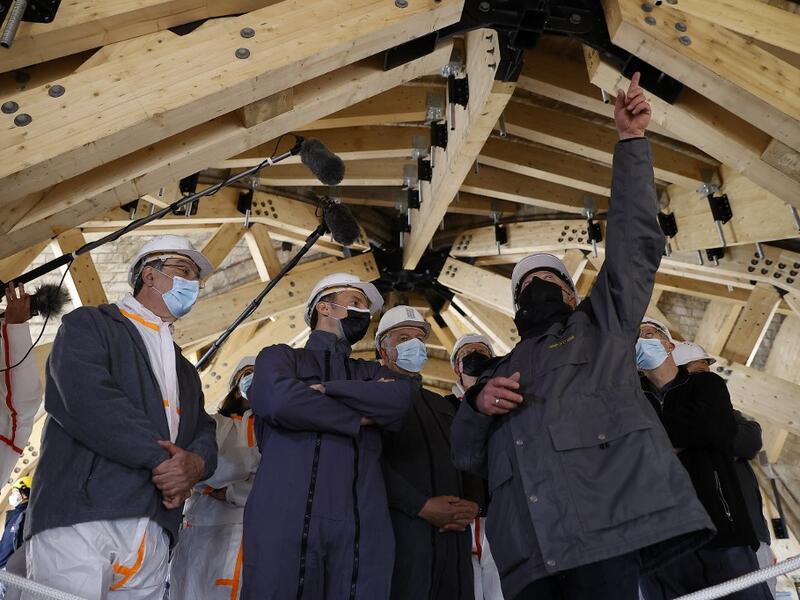 French President Emmanuel Macron (2nd L) listens to the architecte in charge of the restoration Philippe Villeneuve (2nd R) next to Jean-Louis Georgelin (C), a former general leading the restoration efforts, Paris' Archbishop Michel Aupetit (L), and Paris' mayor Anne Hidalgo, during a visit of Notre-Dame de Paris Cathedral 
