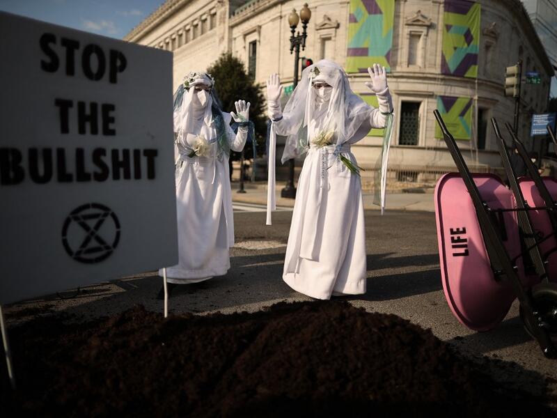 WASHINGTON, DC - APRIL 22: Activists halt traffic and dump a pile of manure outside the White House while protesting against President Joe Biden's climate change policy on Earth Day