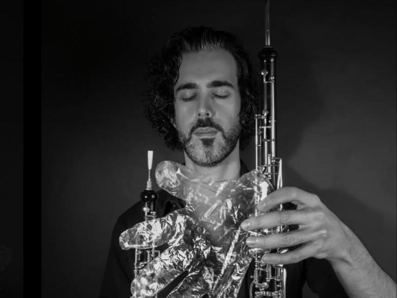 A musician in foil gloves is playing an instrument