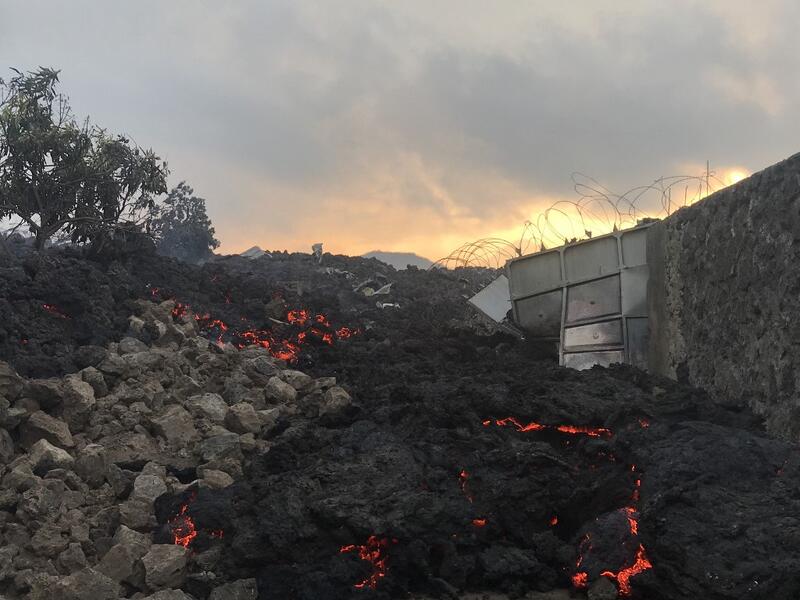Smoldering ashes are seen early morning in Goma in the East of the Democratic Republic of Congo on May 23, 2021 following the eruption of Mount Nyiragongo. Thousands have fled a volcanic eruption in the Democratic Republic of Congo with lava from Mount Nyiragongo reaching Goma city early Sunday. Even before the official announcement, people had started filling the streets and carrying what they could as they headed out of the city, where the last major eruption killed 100 people