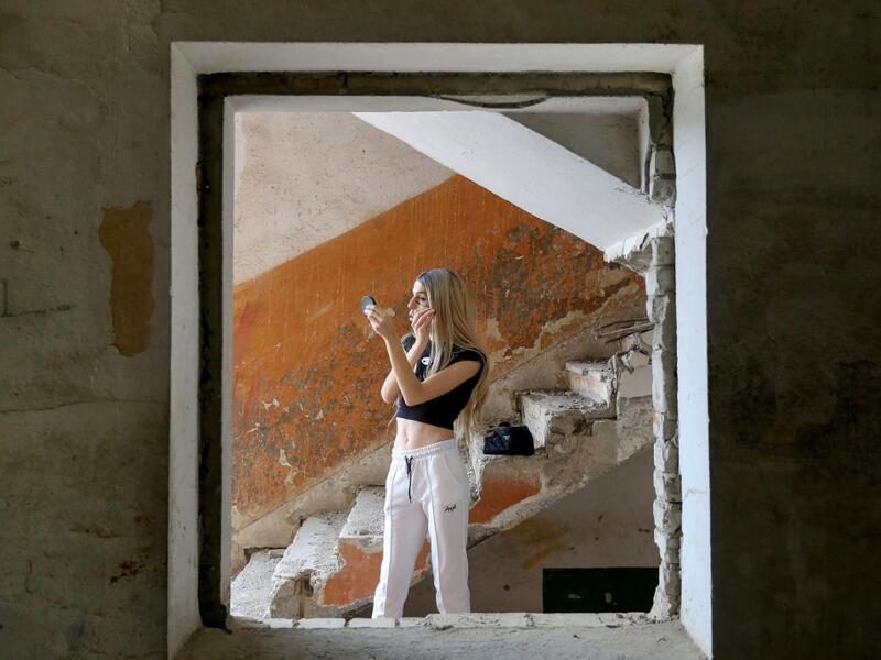 Albanian transgender Denisa, puts her makeup on, in the former Communist-era maximum security prison for political prisoners in Spac