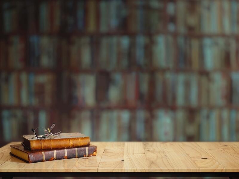 Vintage books on table in library.
