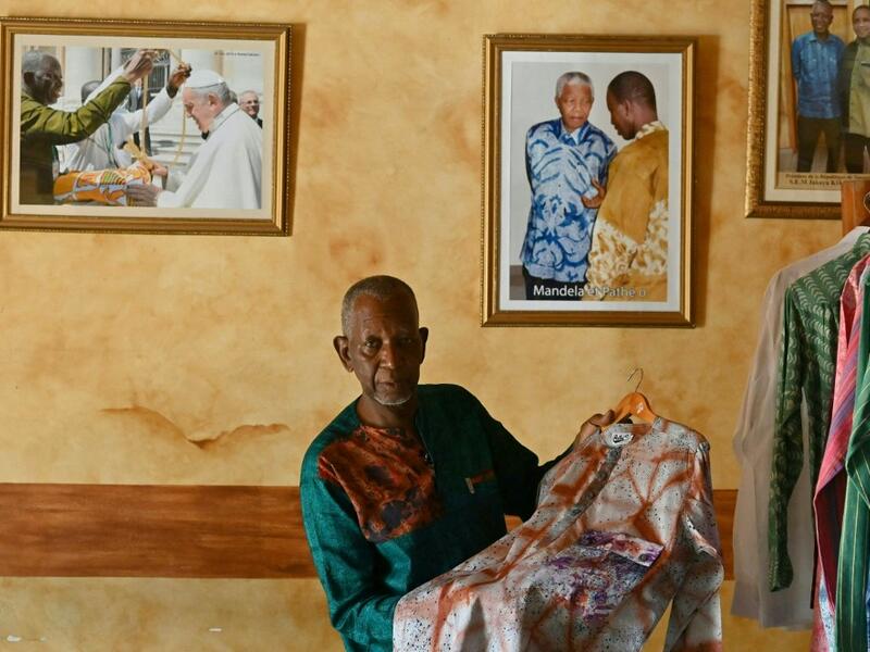 Ivorian-Burkinabe fashion designer Pathé Ouedraogo, known as Pathé'O, poses for a photograph in his store in Abidjan on May 26, 2021. A small self-taught tailor in his early years, the Ivorian-Burkinabe Pathe'O became the designer of African heads of state and celebrates the fiftieth anniversary of his brand, leading the "fight" for the recognition of fashion on the continent