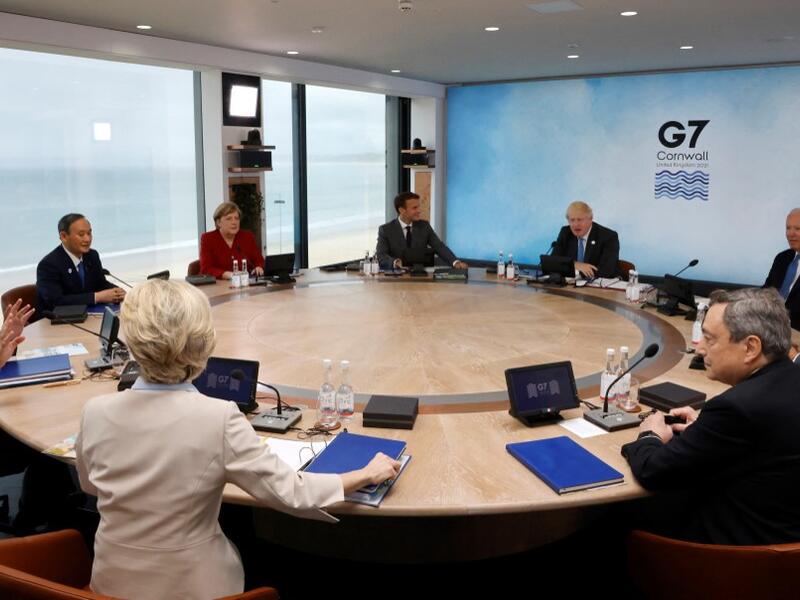 L-R) President of the European Council Charles Michel, President of the European Commission Ursula von der Leyen, Japan's Prime Minister Yoshihide Suga, Germany's Chancellor Angela Merkel, France's President Emmanuel Macron, Britain's Prime Minister Boris Johnson, US President Joe Biden, Canada's Prime Minister Justin Trudeau and Italy's Prime minister Mario Draghi attend a working sesssion at the G7 summit in Carbis Bay