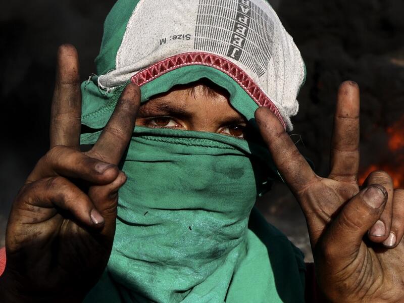 Palestinians burn tires during demonstrations against the expansion of the Jewish settlement outpost of Eviatar, on the lands of Beita village, near the occupied West Bank city of Nablus