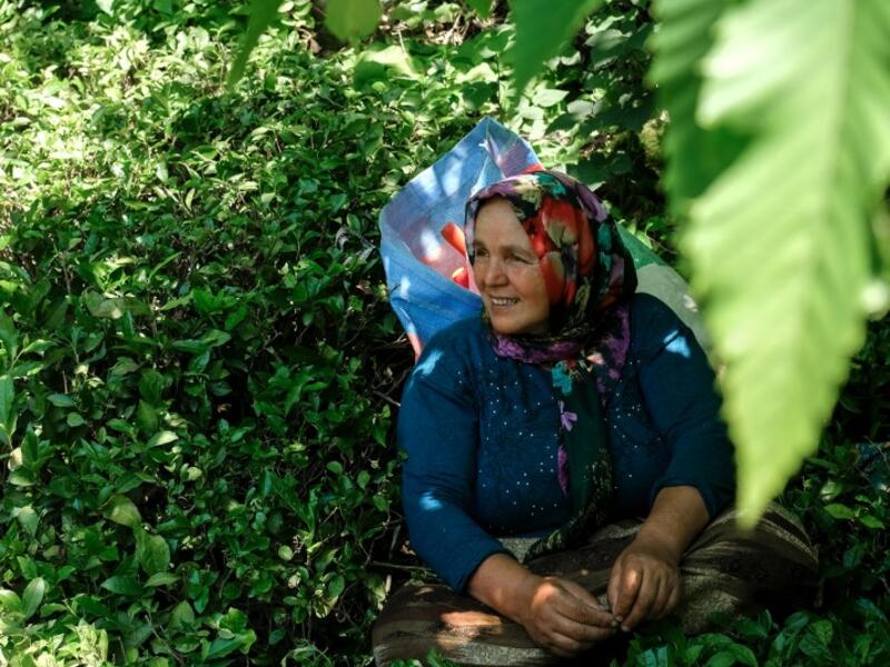 Pervin Bas, takes a break in her 'tea garden' where she picks tea leaves as she speaks to AFP, on June 7, 2021, at Ikizdere in the Rize Province in the Black Sea region of Turkey. A government-friendly company plans to extract 20 million tons of stone from a quarry in the northeastern town of Ikizdere for one of President Recep Tayyip Erdogan